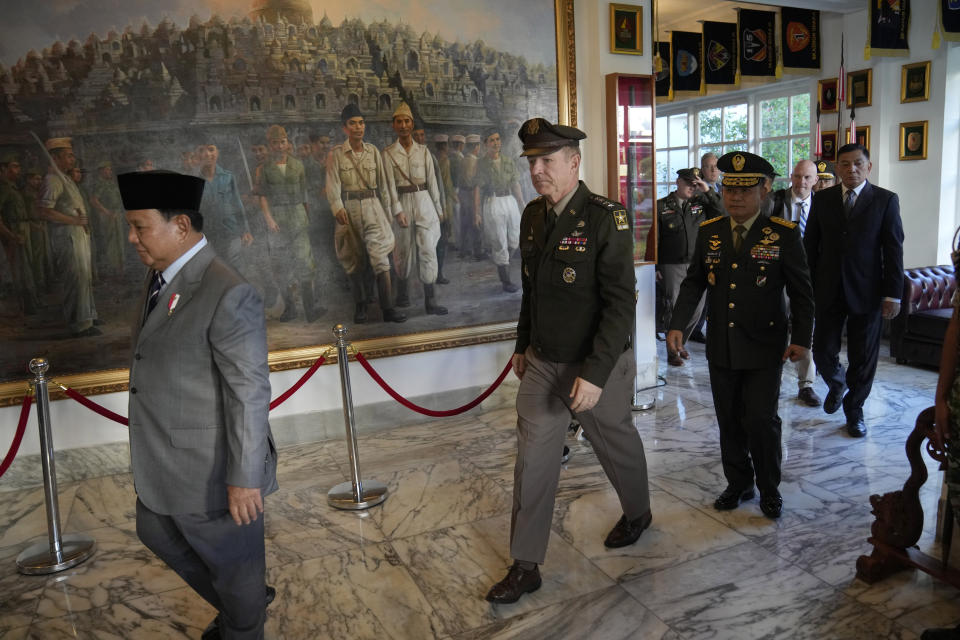 U.S. Army Chief of Staff Gen. James McConville, center, walks with Indonesian Defense Minister Prabowo Subianto, left, and Indonesian Army Chief of Staff Gen. Dudung Abdurachman, second right, during their meeting in Jakarta, Indonesia, Friday, May 12, 2023. (AP Photo/Dita Alangkara)