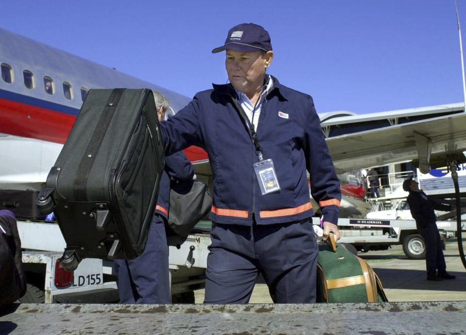 FILE - U.S. Sen. Bob Graham, D-Fla., unload bags from a USAir jet on the tarmac at Tampa International Airport Tuesday afternoon Jan. 9, 2001 in Tampa, Fla. Graham, who gained national prominence as chairman of the Senate Intelligence Committee in the aftermath of the 2001 terrorist attacks and as an early critic of the Iraq war, has died, Tuesday, April 16, 2024. He was 87. (AP Photo/Chris O'Meara, File)