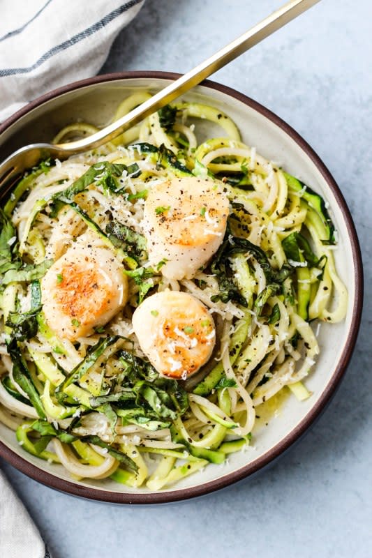 <p>Walder Wellness</p><p>This simple pan-seared scallops and zucchini noodle pasta is a nutritious, healthy and balanced weeknight meal. Dinner in 30 minutes! Gluten-free and dairy-free versions are available.</p><p><strong>Get the recipe: <a href="https://www.walderwellness.com/pan-seared-scallops-zucchini-noodle-pasta/" rel="nofollow noopener" target="_blank" data-ylk="slk:Pan-Seared Scallops with Zucchini Noodle Pasta;elm:context_link;itc:0;sec:content-canvas" class="link rapid-noclick-resp">Pan-Seared Scallops with Zucchini Noodle Pasta</a></strong></p>