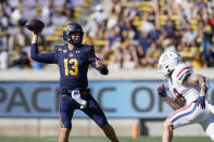 California quarterback Jack Plummer (13) throws a pass while being pressured by Arizona safety Gunner Maldonado (9) during the first half of an NCAA college football game in Berkeley, Calif., Saturday, Sept. 24, 2022. (AP Photo/Godofredo A. Vásquez)