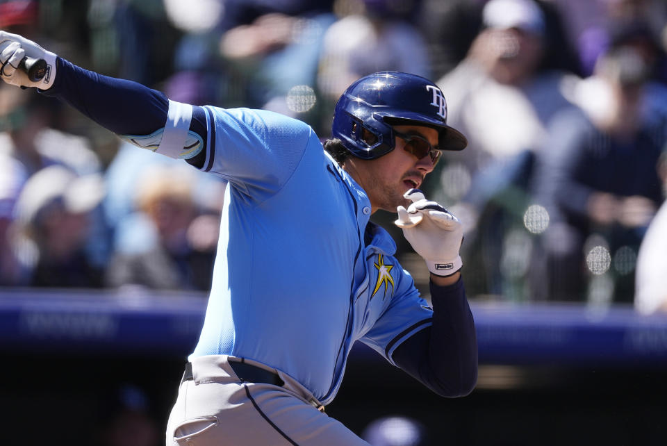 Tampa Bay Rays' Austin Shenton follows the flight of his RBI single off Colorado Rockies pitcher Dakota Hudson in the second inning of a baseball game Sunday, April 7, 2024, in Denver. (AP Photo/David Zalubowski)