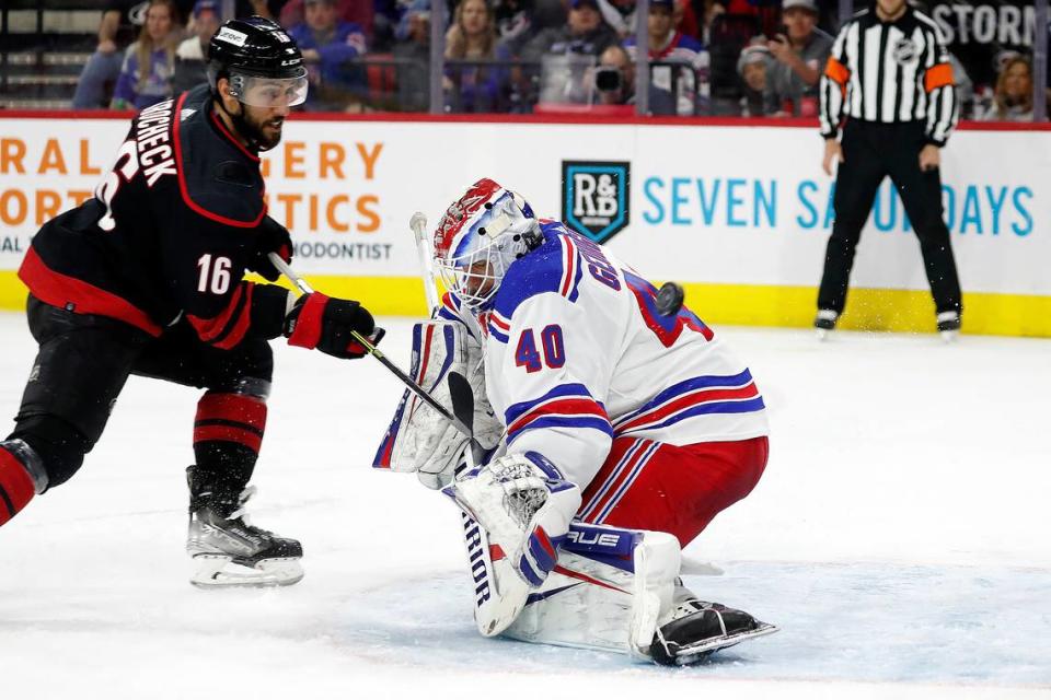 Carolina Hurricanes’ Vincent Trocheck (16) has his shot go over the shoulder of New York Rangers goaltender Alexandar Georgiev (40) during the second period of an NHL hockey game in Raleigh, N.C., Sunday, March 20, 2022. (AP Photo/Karl B DeBlaker)