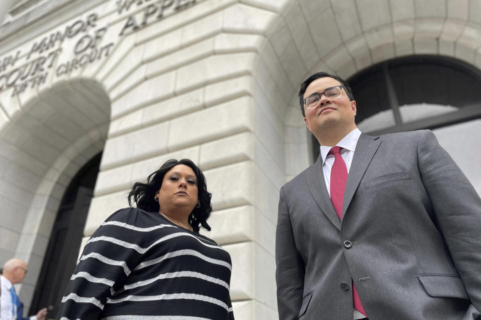 Priscilla Villarreal, an online journalist from Laredo, Texas, stands outside the 5th U.S. Circuit Court of Appeals building in New Orleans on Wednesday, Jan. 25, 2023, with her attorney, J.T. Morris, after the court heard arguments in Villarreal's lawsuit against Laredo and Webb County, Texas, authorities. Her suit says she was wrongfully arrested by Laredo and Webb County authorities in 2017 for seeking information from police. The criminal charge against her was dismissed by a Texas judge in 2018. (AP Photo/Kevin McGill)