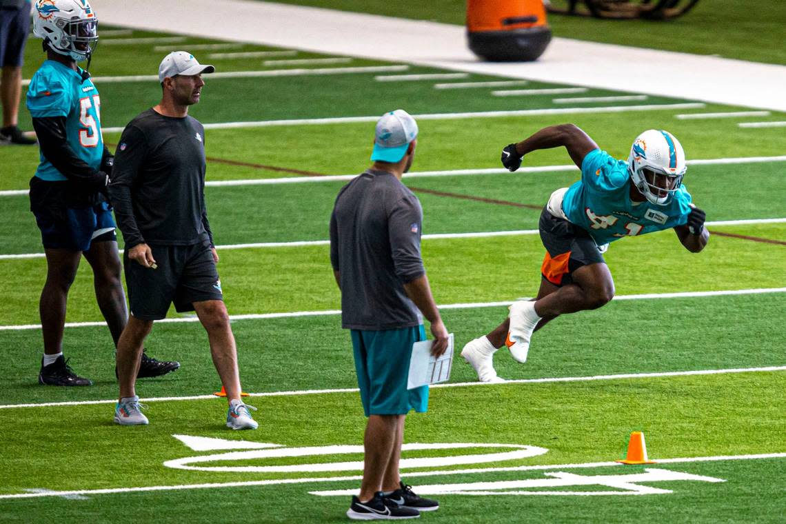 Miami Dolphins linebacker coach Anthony Campanile watches as linebacker Channing Tindall (41) sprints for a drill during Dolphins practice at Baptist Health Training Complex in Miami Gardens on Wednesday, October 26, 2022.