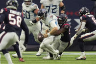 Tennessee Titans quarterback Ryan Tannehill (17) loses the ball as he is sacked by Houston Texans defensive end Jordan Jenkins (50) during the second half of an NFL football game, Sunday, Jan. 9, 2022, in Houston. Tennessee recovered the ball. (AP Photo/Eric Christian Smith)