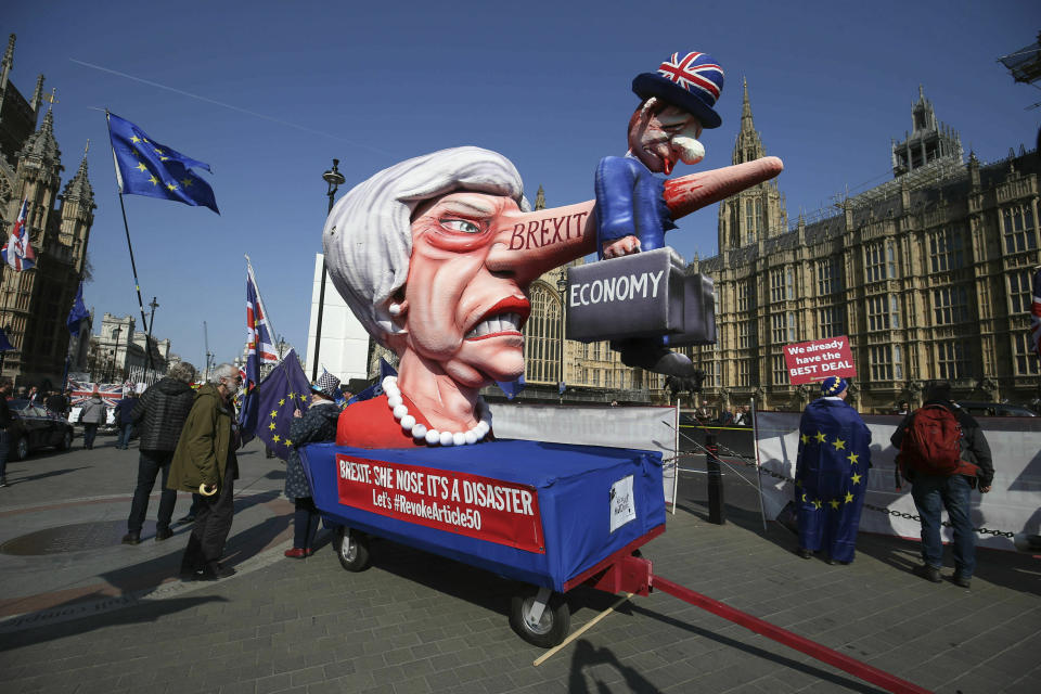 Anti-Brexit demonstrators with an effigy of British Prime Minister Theresa May near College Green at the Houses of Parliament in London, Monday, April 1, 2019. Britain's Parliament gets another chance Monday to offer a way forward on Britain's stalled divorce from the European Union, holding a series of votes on Brexit alternatives in an attempt to find the elusive idea that can command a majority. (Jonathan Brady/PA via AP)