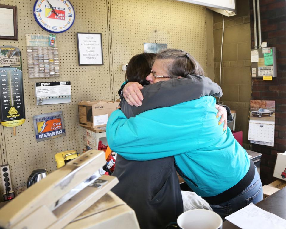 Maine Meat co-owner Shannon Hill hugs Best Automotive owner Cissy Furbish, expressing the gratitude she and Jarrod Spangler feel over a deal to purchase the property to expand their business.