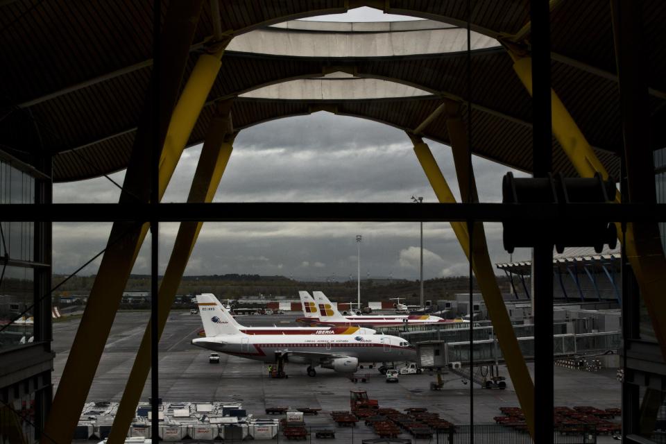 Iberia jets are seen in a parking zone at Barajas international airport in Madrid, Friday, Nov. 9, 2012. International Airlines Group on Friday warned that its Spanish carrier Iberia was "in a fight for survival" and unveiled a restructuring plan to cut 4,500 jobs as it reported a drop in third-quarter profit. (AP Photo/Daniel Ochoa de Olza)