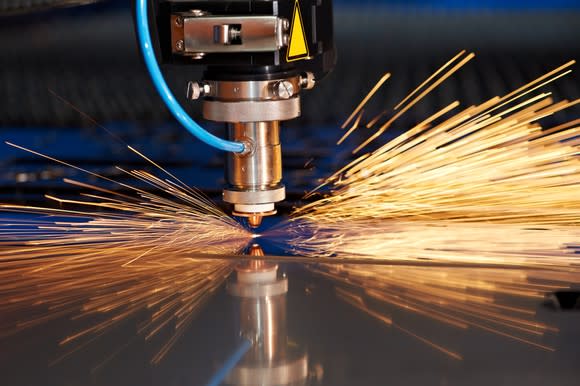 Laser drill in use with sparks flying.