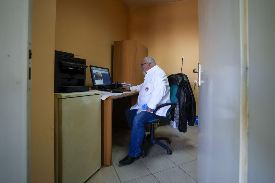 Doctor Vidak Simic who examined over 40 corpses of migrants and refugees retrieved from the river since 2017 works in hospital in Bijeljina, eastern Bosnia, Sunday, Feb. 4, 2024. In several cities along this river between Bosnia and Serbia, simple, durable gravestones now mark the final resting places of dozens of refugees and migrants who drowned in the area while trying to reach Western Europe.(AP Photo/Darko Vojinovic)