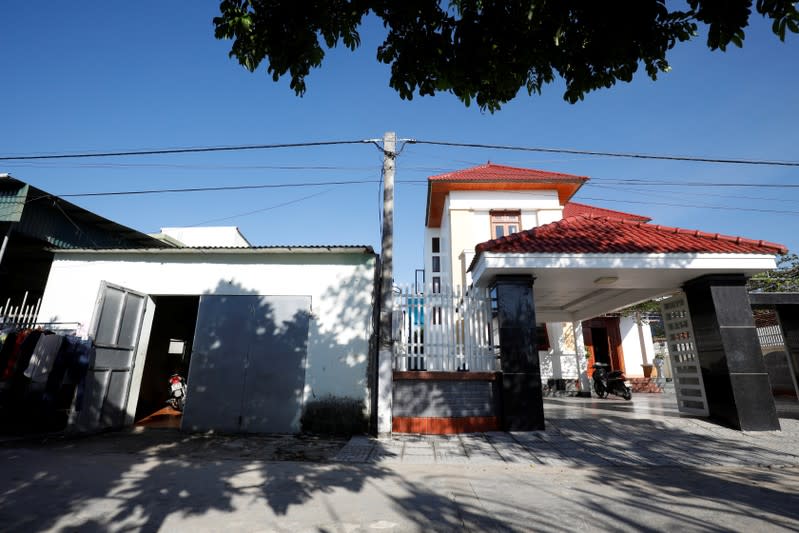 The newly-built house of Bui Chung, who worked in Britain, is seen next to an older house belonging to his relative Bui Van Diep, a local welding worker, at Do Thanh commune, in Nghe An province