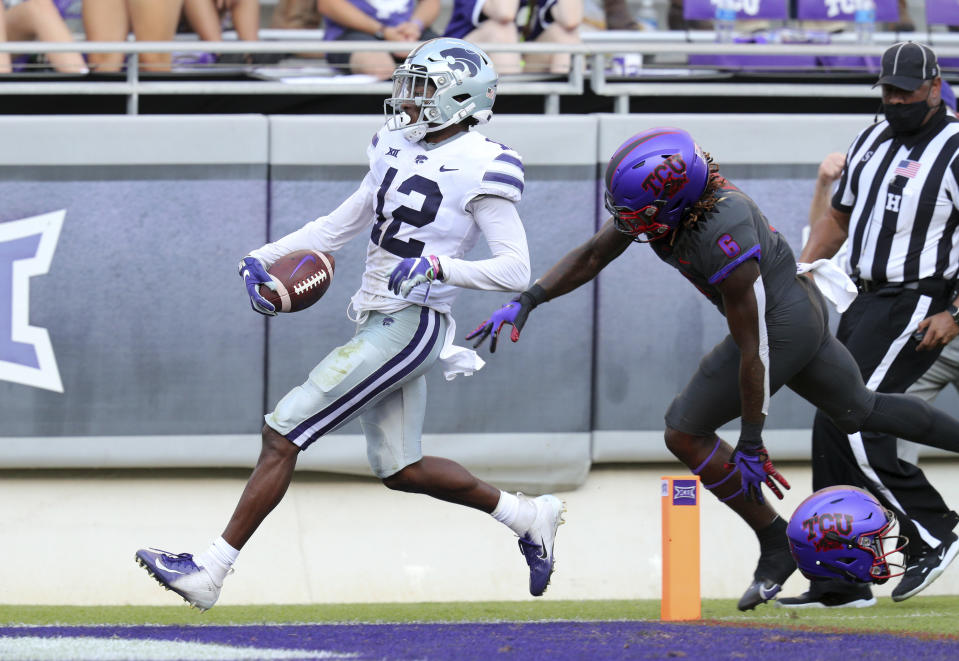 Kansas State defensive back AJ Parker (12) scores on an interception ahead of TCU running back Zach Evans (6) in the third quarter of an NCAA college football game Saturday, Oct. 10, 2020, in Fort Worth, Texas. (AP Photo/Richard W. Rodriguez)