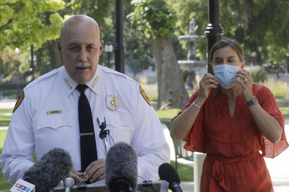 FILE - In this Aug. 3, 2020 file photo, Salt Lake City police Chief Mike Brown speaks as Mayor Erin Mendenhal listens during a news conference on Aug. 3, 2020, in Salt Lake City. The Salt Lake City Police Department vowed Tuesday, Sept. 8, 2020, to cooperate with multiple investigations of the shooting of a 13-year-old autistic boy by officers in the Salt Lake City area. The Salt Lake City Police Department said the officers were called to a home in Glendale, Utah, Friday night, Sept. 4 with a report of a boy who had threatened people with a weapon. The boy reportedly ran and was shot by an officer after being pursued by police. (AP Photo/Rick Bowmer, File)