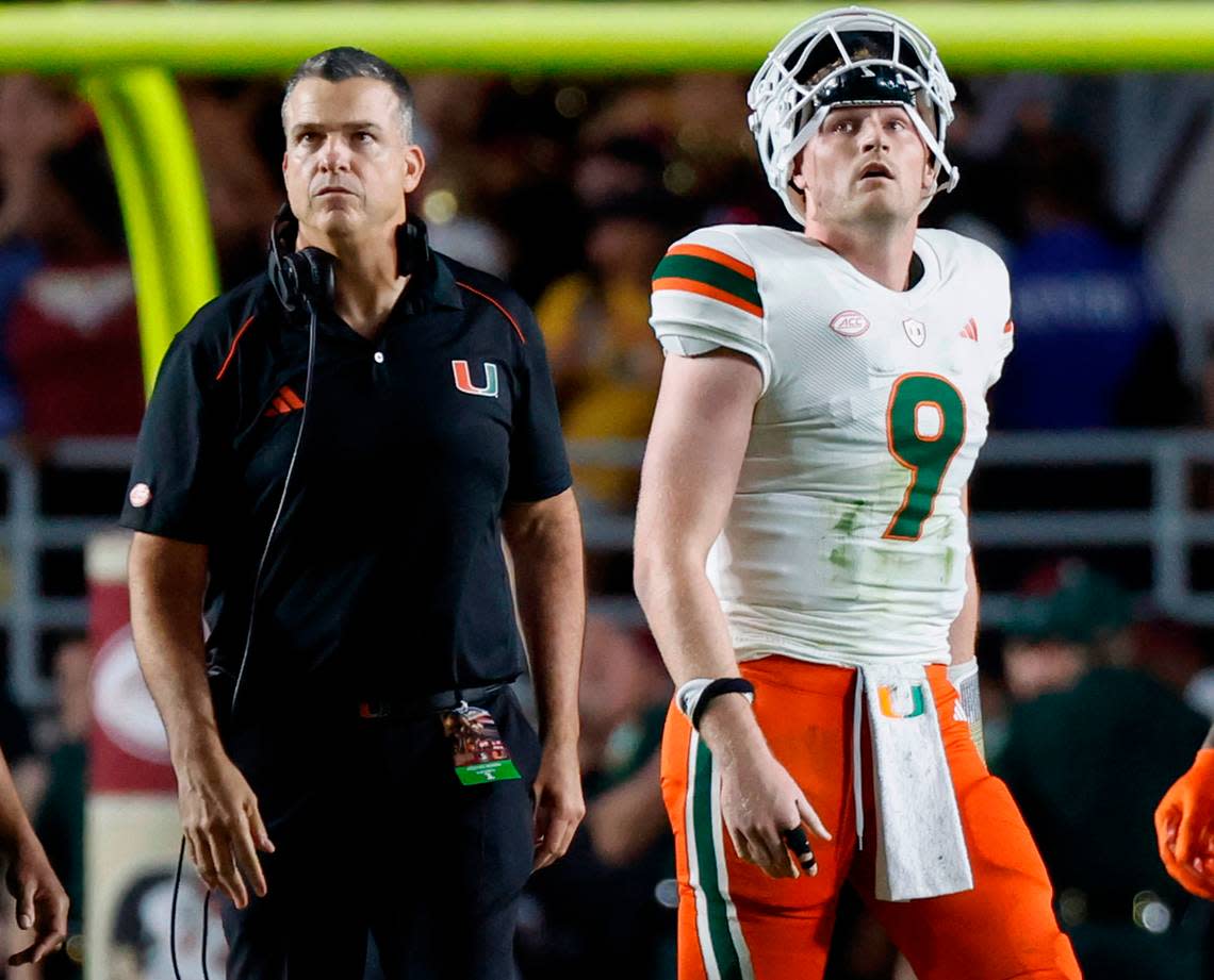 Miami Hurricanes head coach Mario Cristobal and quarterback Tyler Van Dyke (9) wait for the call by the officials in the final seconds of the game against the Florida State Seminoles at Doak Campbell Stadium in Tallahassee on Saturday, November 11, 2023.