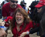 Jennifer Sterling, one of the organizers of the pro-Trump rally, reacts after getting hit with pepper spray by a counter-protester during a march in support of President Donald Trump, in Huntington Beach, Calif., on Saturday, March 25, 2017. The event became violent with several arrests and injuries. (Mindy Schauer/The Orange County Register via AP)