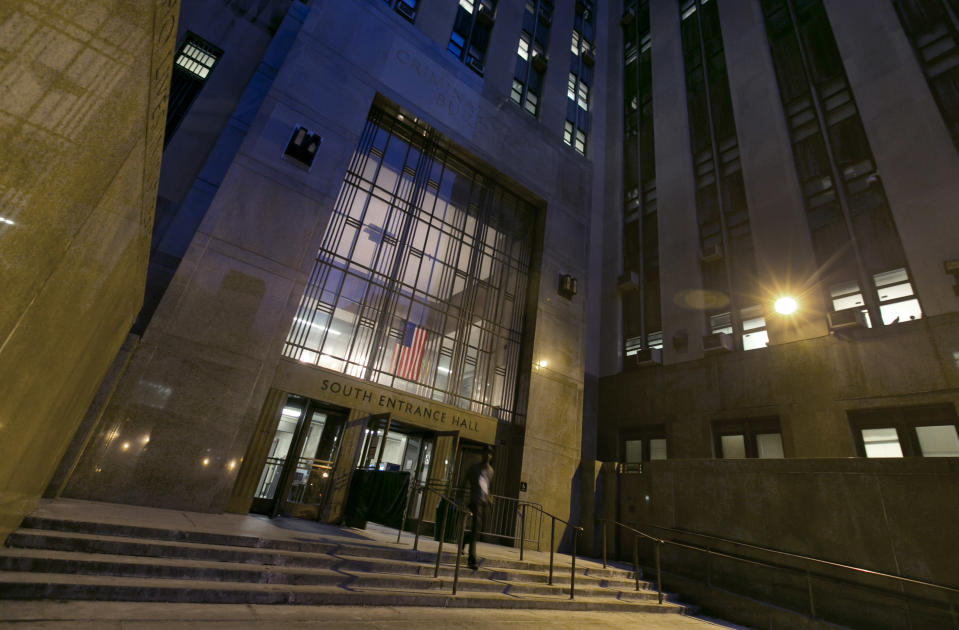 A man leaves New York's Criminal Court Building, Tuesday evening March 11, 2014. Night Court is one of New York’s more peculiar and paradoxical tourist traditions, a place visitors extol on travel websites while many residents hope never to wind up there. To travelers, it’s gritty entertainment, hard-knocks education or at least a chance to experience real-life law and order on a New York scale. (AP Photo/Richard Drew)