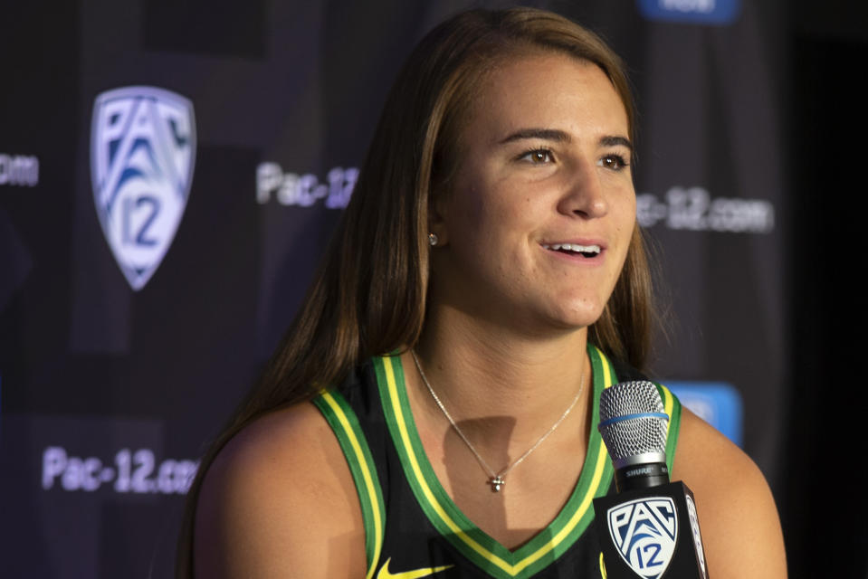 FILE - In this Oct. 7, 2019, file photo, Oregon's Sabrina Ionescu speaks to reporters during the Pac-12 Conference women's NCAA college basketball media day in San Francisco. Ionescu earned a spot on The Associated Press women's basketball All-America team Thursday, March 19, 2020, as a unanimous choice from the national media panel that votes on the Top 25 each week. (AP Photo/D. Ross Cameron, File)