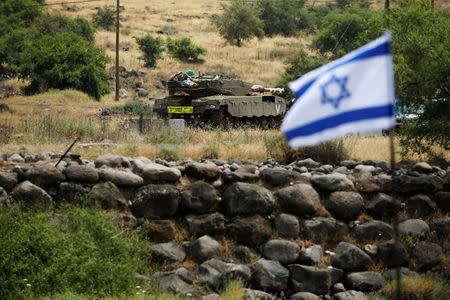 An Israeli tank can be seen near the Israeli side of the border with Syria in the Israeli-occupied Golan Heights, Israel May 9, 2018. REUTERS/Amir Cohen
