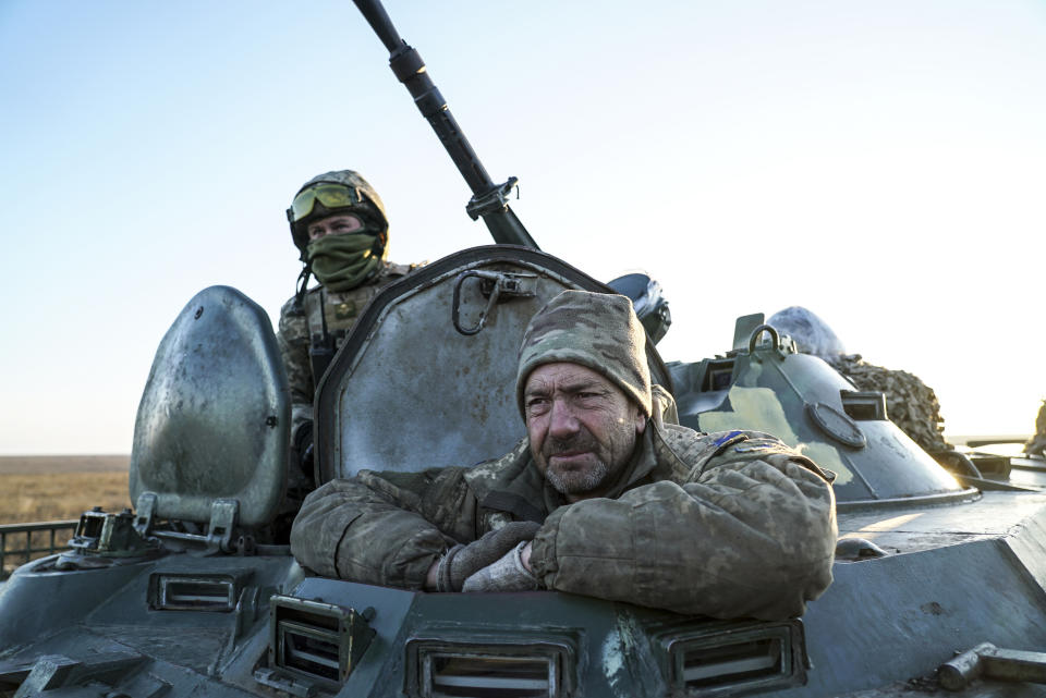 Ukrainian soldiers sit atop an APC near Urzuf, south coast of Azov sea, eastern Ukraine, Thursday, Nov. 29, 2018. Ukraine put its military forces on high combat alert and announced martial law this week after Russian border guards fired on and seized three Ukrainian ships in the Black Sea. (AP Photo/Evgeniy Maloletka)