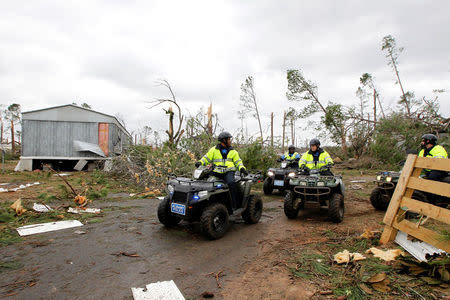 Albany policemen patrol Big Pine Estates Mobile Home Park after a tornado struck the residential area on Sunday in Albany, Georgia. REUTERS/Tami Chappell