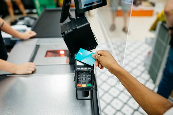 a credit card being used at a cashier