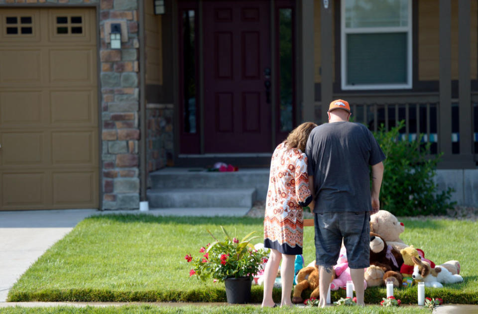 A photo shows neighbours at a memorial out the front of the Watts family house in August. Source: Getty Images