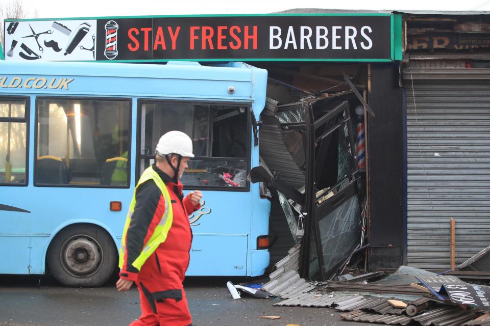 The scene in Handsworth Road, Sheffield, where a school bus crashed into the front of a barbers shop (PA)