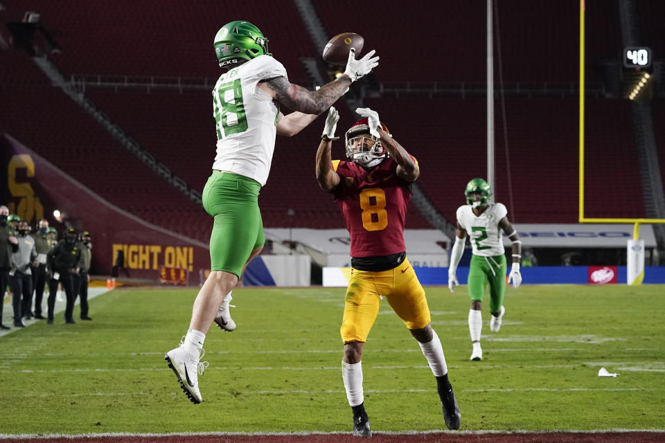 Oregon tight end Hunter Kampmoyer (48) catches a pass in the end zone for a touchdown against Southern California cornerback Chris Steele (8) during the first quarter of an NCAA college football game for the Pac-12 Conference championship Friday, Dec 18, 2020, in Los Angeles. (AP Photo/Ashley Landis)