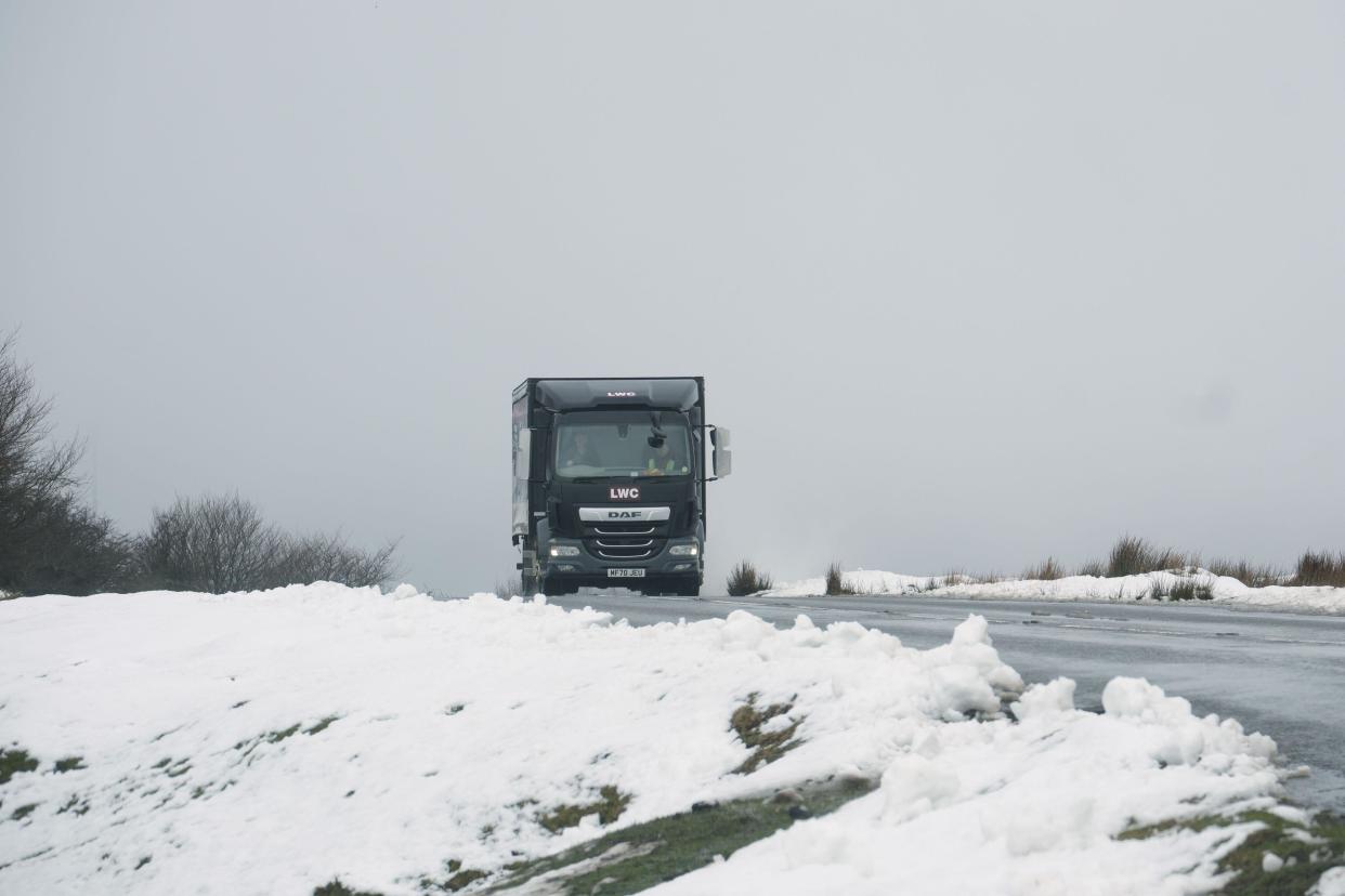 A van drives through snowy conditions on Dartmoor. (PA)