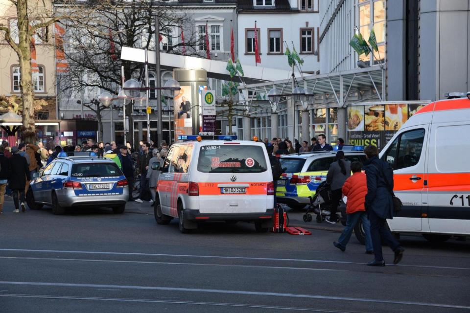 Police vehicle and ambulance stand in front of a business building in Heidelberg. (AFP/Getty Images)