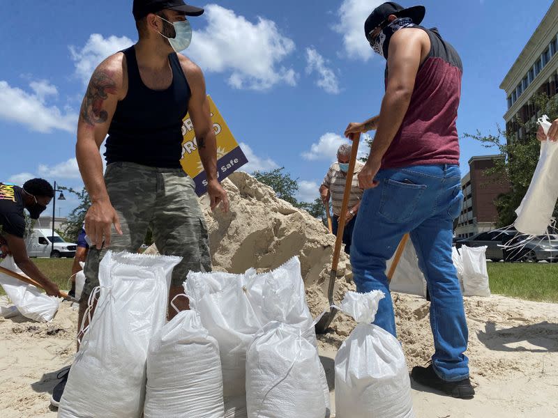 Residents fill and collect sand bags before the expected arrival of Hurricane Isaias in Doral