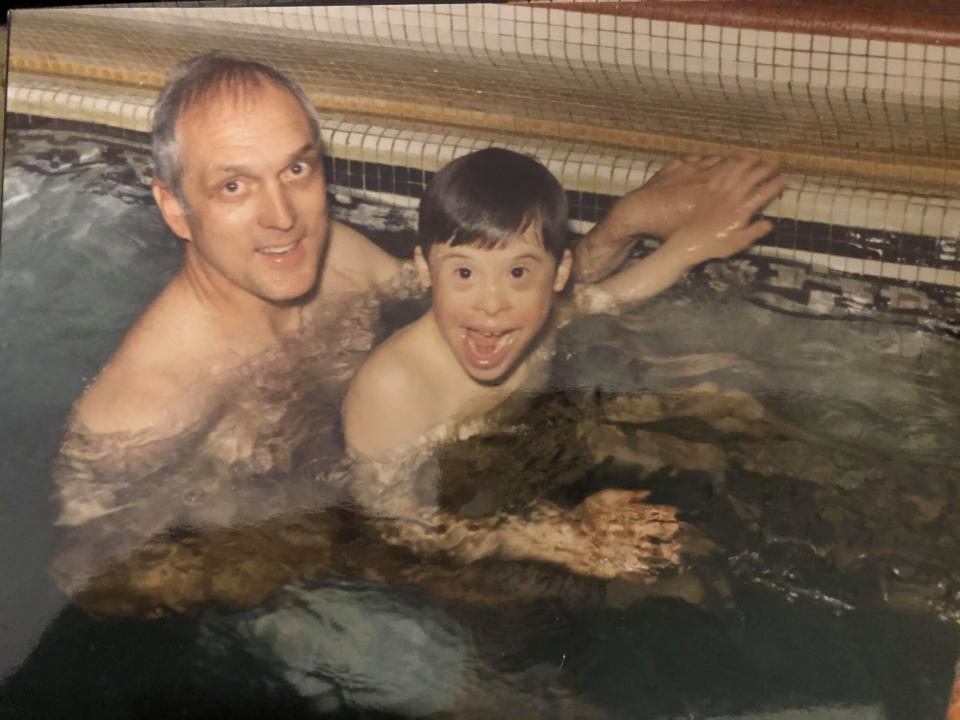 A young Jimmy Erskine plays with his father, Carl Erskine, at a pool.