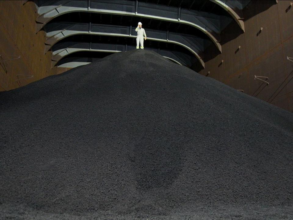 Barron stands atop the pile of nodules collected from the bottom of the ocean.