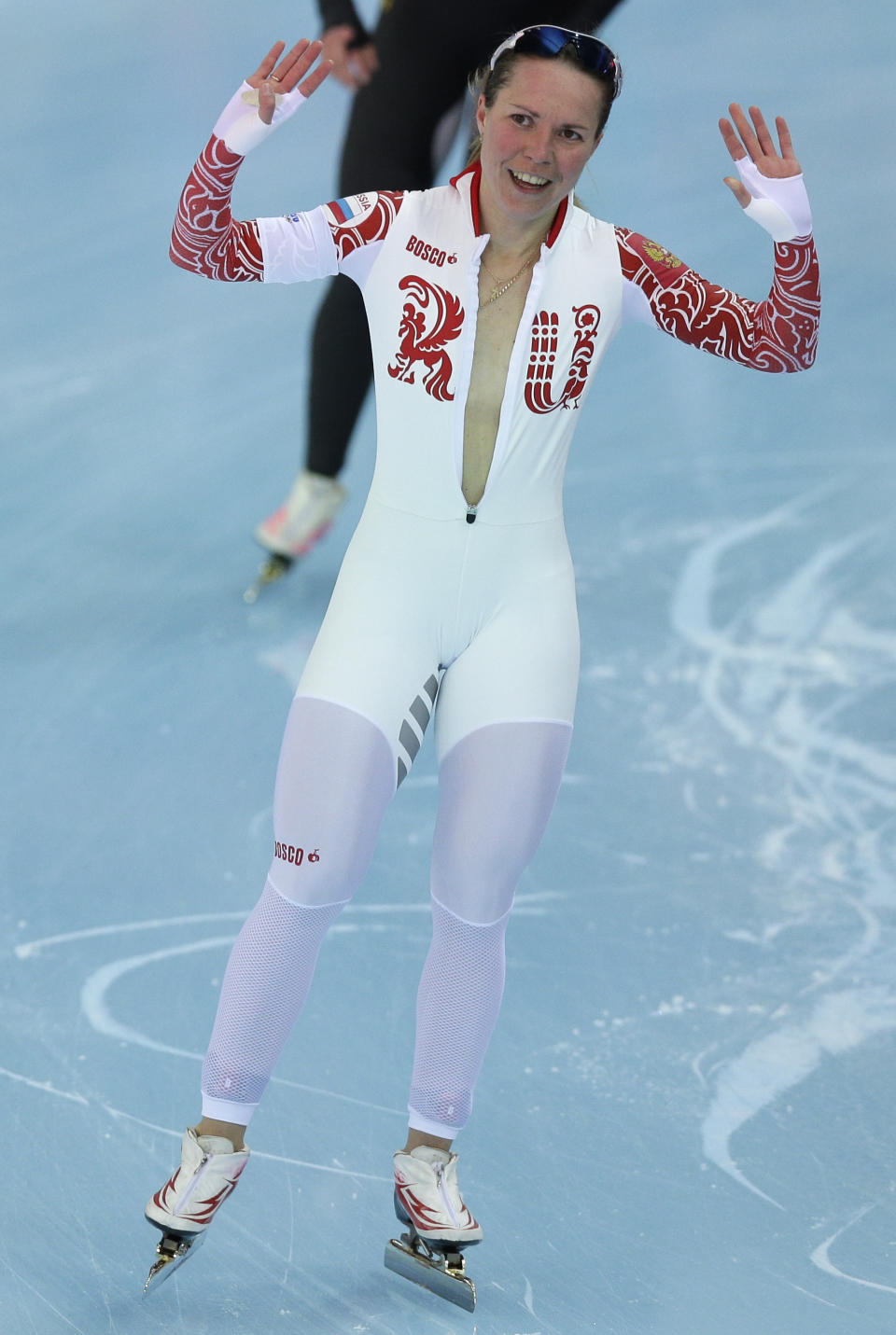 Bronze medallist Olga Graf of Russia celebrates with a wide open front of her skin suit after the women's 3,000-meter speedskating race at the Adler Arena Skating Center during the 2014 Winter Olympics, Sunday, Feb. 9, 2014, in Sochi, Russia. (AP Photo/Pavel Golovkin)