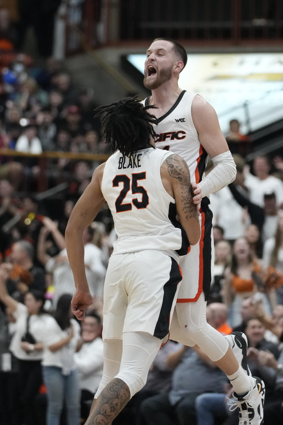 Pacific guard Luke Avdalovic, right, celebrates with guard Nick Blake after scoring a 3-point basket against Gonzaga during the first half of an NCAA college basketball game in Stockton, Calif., Saturday, Jan. 21, 2023. (AP Photo/Godofredo A. Vásquez)