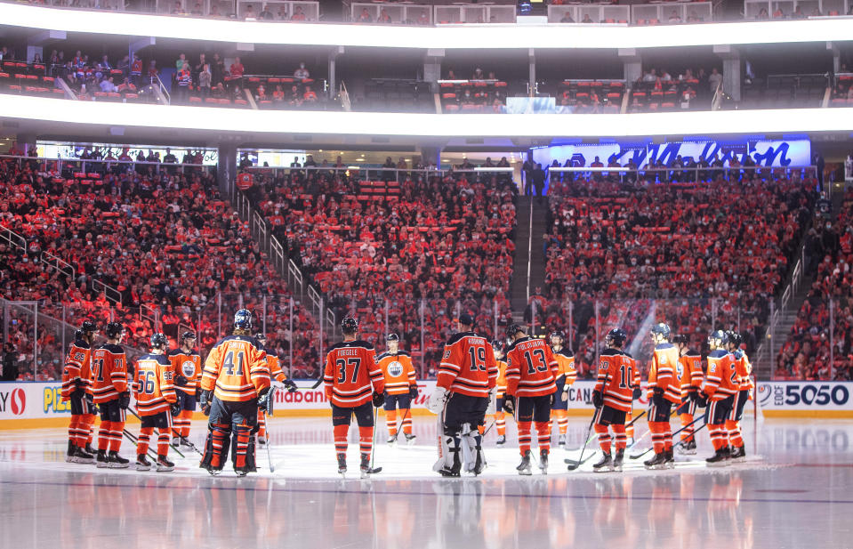 Edmonton Oilers gather around center ice before the team's NHL hockey game against the Vancouver Canucks on Wednesday, Oct. 13, 2021, in Edmonton, Alberta. (Jason Franson/The Canadian Press via AP)