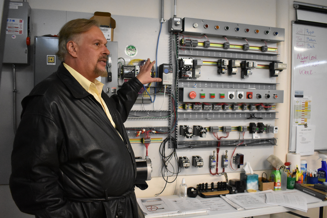 Training Director Shon Lee demonstrates the equipment used by students at the Electrical Joint Apprenticeship and Training Center in Kansas City on Wednesday, Nov. 16, 2022.