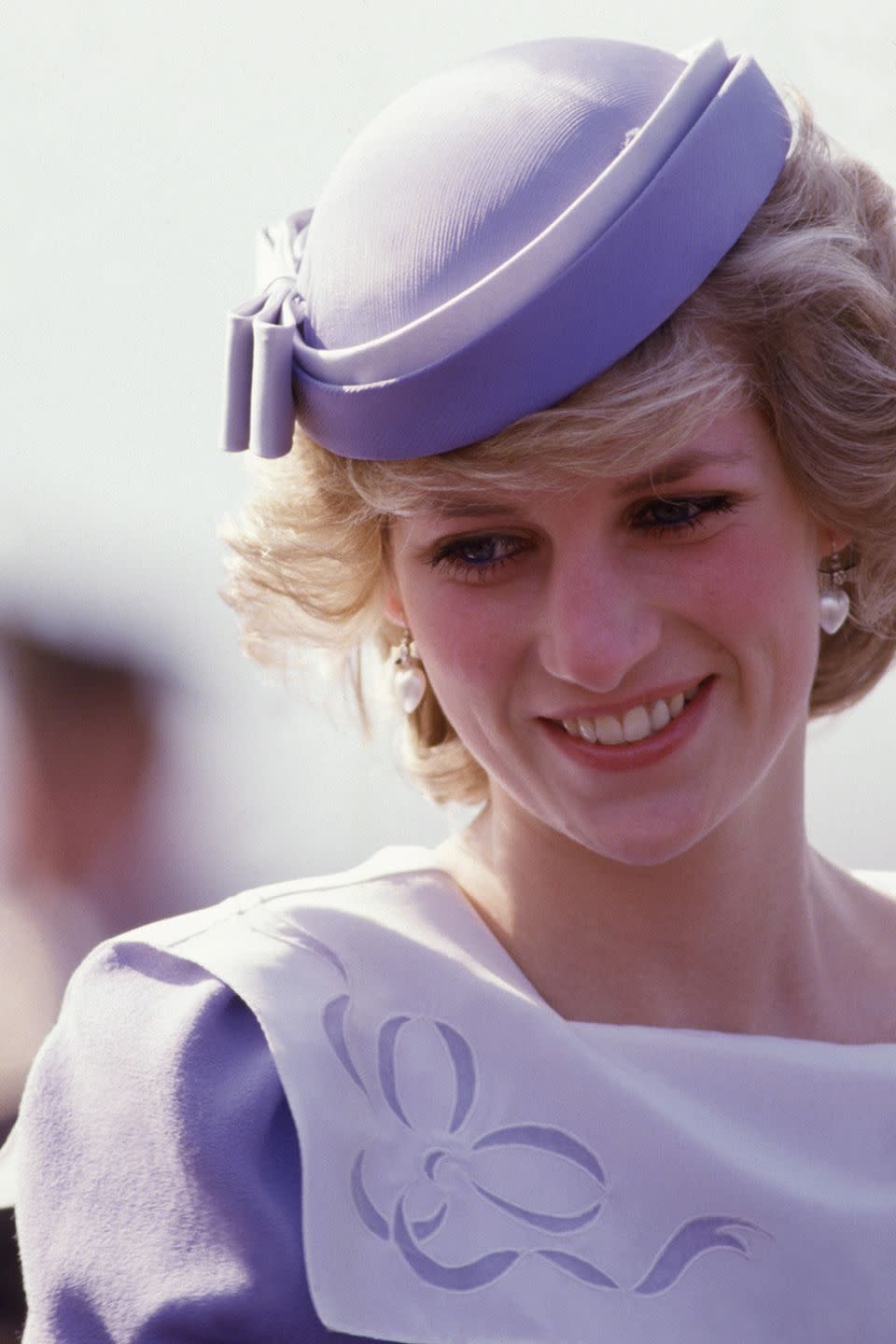 <p>Arriving in Sardinia, Italy wearing a structured lavender pillbox.</p>