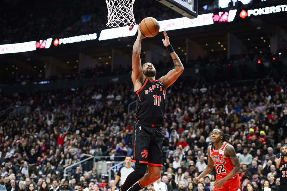 Toronto Raptors forward Bruce Brown (11) scores while Chicago Bulls guard Ayo Dosunmu (12) looks on during second-half NBA basketball game action in Toronto, Thursday, Jan. 18, 2024. (Christopher Katsarov/The Canadian Press via AP)