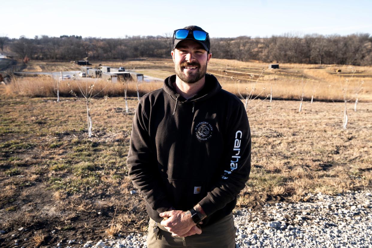 Farm manager Sam Applegate stands for a portrait at In Harmony farm on Nov. 30, 2023, in Earlham.