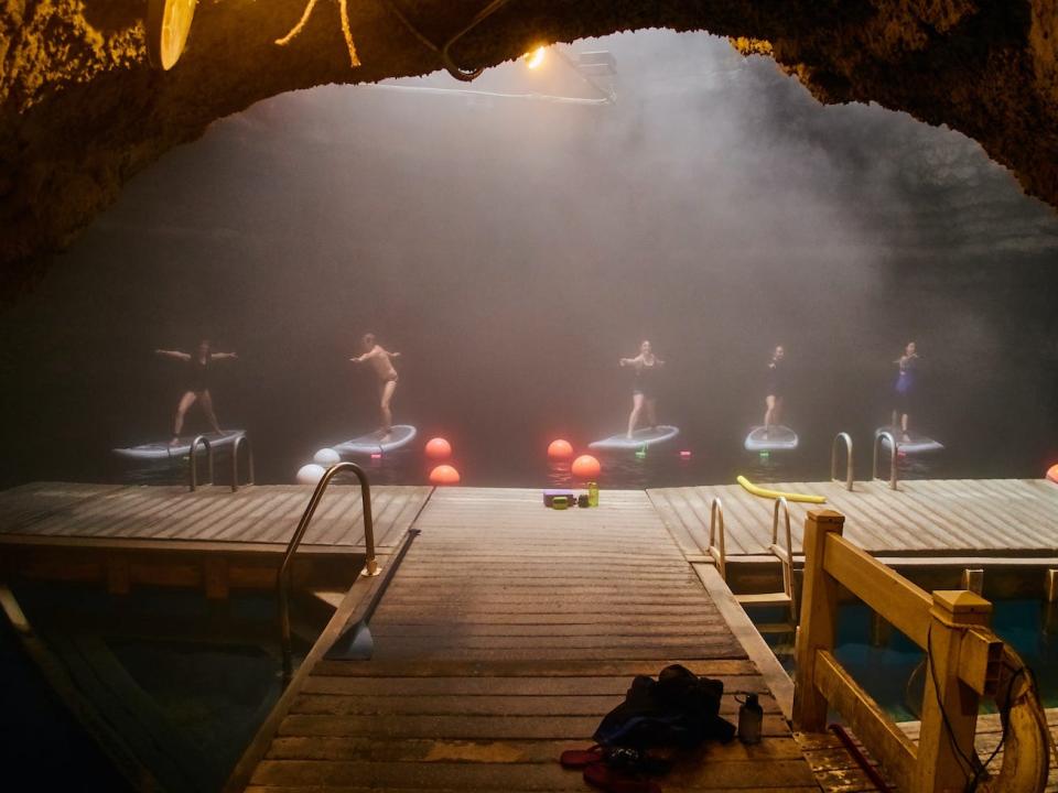 A group does yoga on paddleboards in the Homestead Crater.