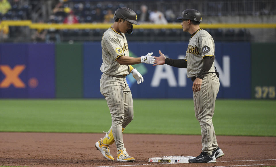 San Diego Padres' Ha-Seong Kim, left, celebrates with first base coach David Macias after hitting a two-run single against the Pittsburgh Pirates during the second inning of a baseball game Tuesday, June 27, 2023, in Pittsburgh. (AP Photo/Justin Berl)