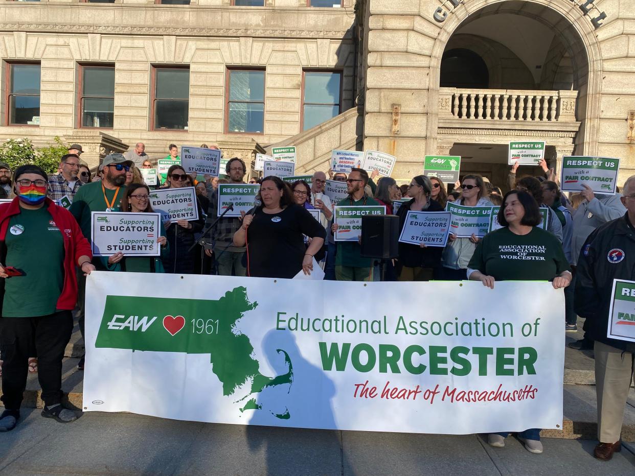 Members of the Educational Association of Worcester rally on the steps of City Hall Friday night.