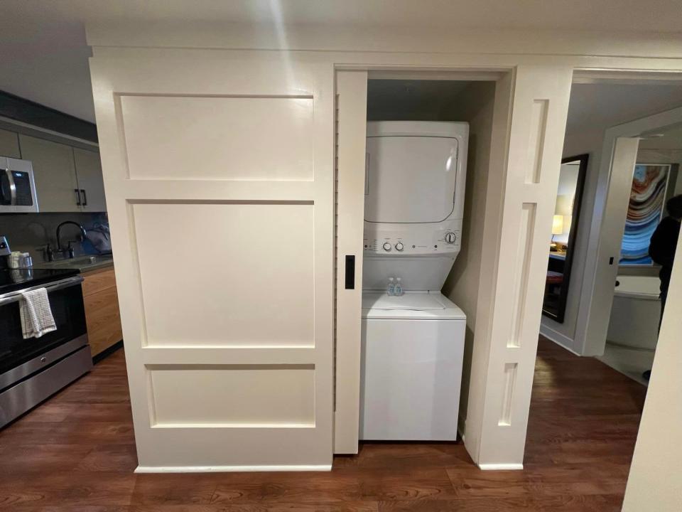 a stackable washer dryer in a closet next to the kitchen in a villa at disney's wilderness lodge