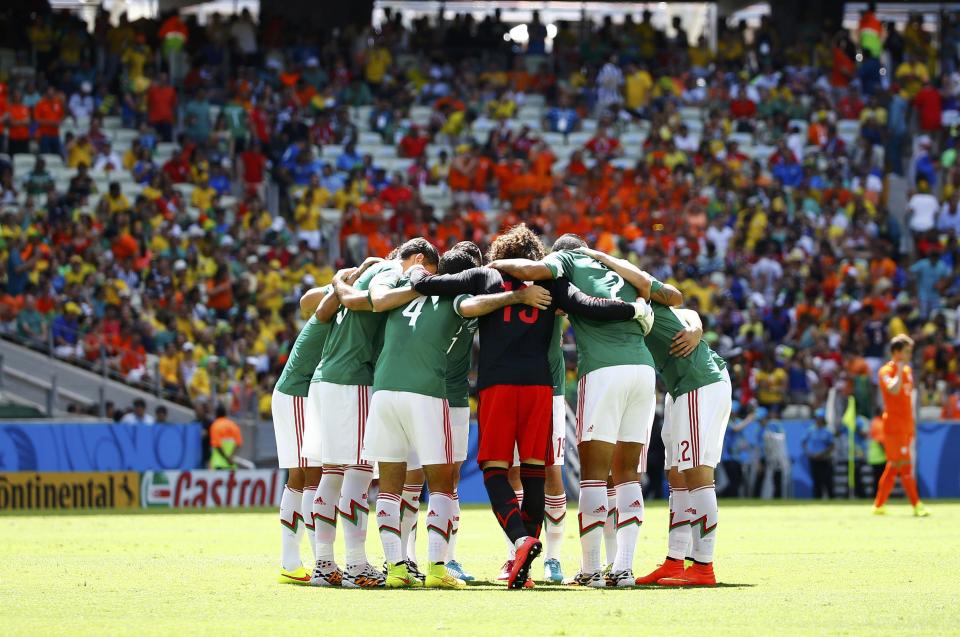 Mexico's players huddle before their 2014 World Cup round of 16 game against the Netherlands at the Castelao arena in Fortaleza