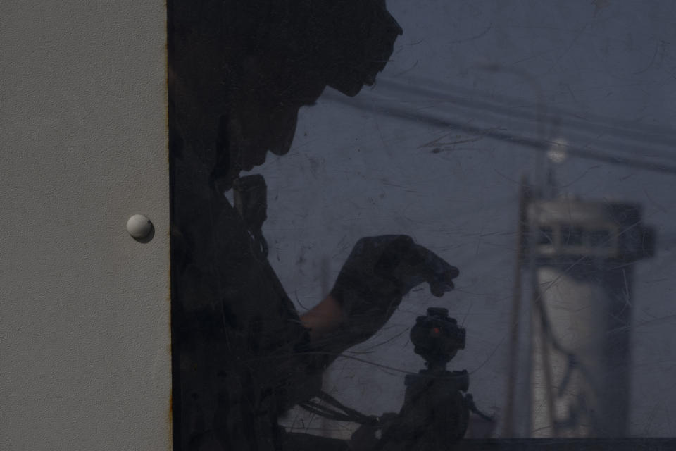 An Israeli soldier adjusts his weapon inside a guard tower at the Gush Etzion junction, the transportation hub for a number of West Bank Jewish settlements, Thursday, June 9, 2022. Israeli settlers in the occupied West Bank may soon have a taste of the military rule that Palestinians have been living under for 55 years. A looming end-of-month deadline to extend legal protections to Jewish settlers has put Israel’s government on the brink of collapse and drawn widespread warnings that the territory could be plunged into chaos. (AP Photo/Maya Alleruzzo)