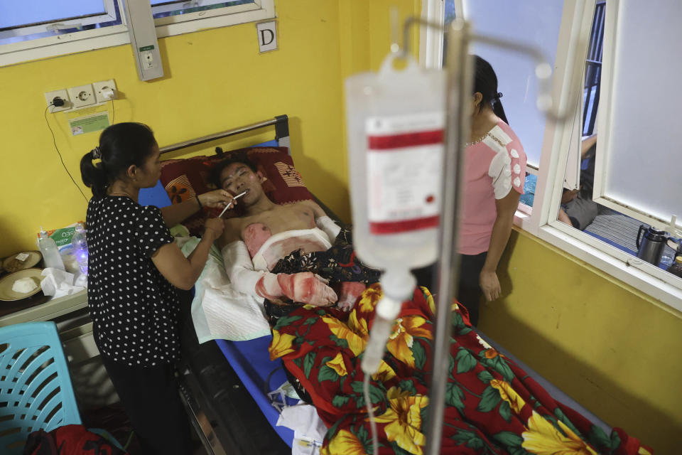 An injured man who suffered from the eruption of Mount Semeru receives treatment at a hospital in Lumajang district, East Java province, Indonesia, Sunday, Dec. 5, 2021. The death toll from the eruption of the highest volcano on Indonesia's most populous island of Java has risen by a score of still missing, officials said Sunday as rain continued to lash the area and hamper the search. (AP Photo/Trisnadi)