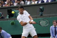 Serbia's Novak Djokovic plays a return to Canada's Denis Shapovalov during the men's singles semifinals match on day eleven of the Wimbledon Tennis Championships in London, Friday, July 9, 2021. (AP Photo/Alberto Pezzali)