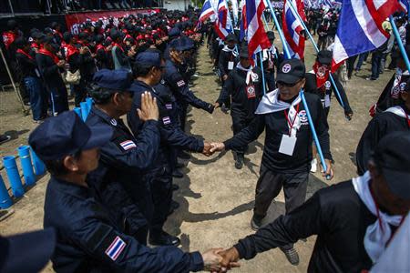 Members of the "Volunteers' Ward to protect the Nation's Democracy" group take part during a march marking the end of their two days training at the stadium in Nakhon Ratchasima, Northeastern province of Thailand, April 21, 2014. REUTERS/Athit Perawongmetha