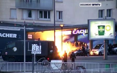 An explosion lighting the front of a kosher supermarket as French police special forces launch their assault, where several people were taken hostage near the Porte de Vincennes in eastern Paris, January 9, 2015. REUTERS/BFMTV via Reuters TV